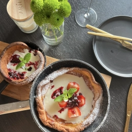 Dutch Baby with champagne whipped cream and fresh berries