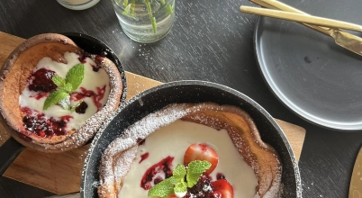 Dutch Baby with champagne whipped cream and fresh berries
